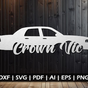May include: White silhouette of a Crown Vic car with the words "Crown Vic" written underneath. The image is on a dark wood background.