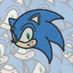 May include: A blue and black embroidered patch of Sonic the Hedgehog, a popular video game character. The patch features Sonic's signature grin and blue quills.