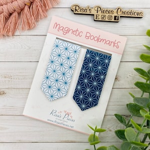 May include: Two magnetic bookmarks with a geometric pattern in shades of blue and white. The bookmarks are displayed on a white card with the text "Magnetic Bookmarks" and "Risa's Pieces Creations".