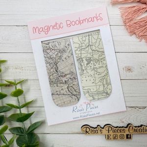 May include: Two vintage map-style magnetic bookmarks. The bookmarks are on a white background with the text "Magnetic Bookmarks" and "Risa's Pieces Creations" in pink lettering.