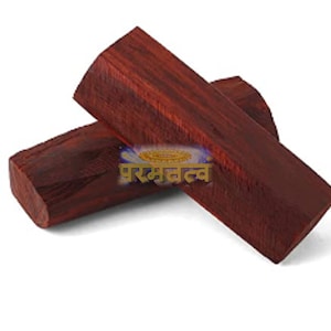 May include: Two dark red wooden sticks, possibly used for incense or meditation.