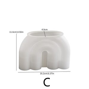 May include: A white, arch-shaped container with dimensions labeled as 16.2cm/6.37in wide, 11.6cm/4.56in tall, and 4.9cm wide at the top. The container has a rounded, open top and a curved, open base, with the letter "C" at the bottom.