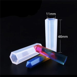 May include: A set of three clear silicone molds for making hexagonal crystal-shaped resin crafts. The molds are 46 mm long and 11 mm wide.