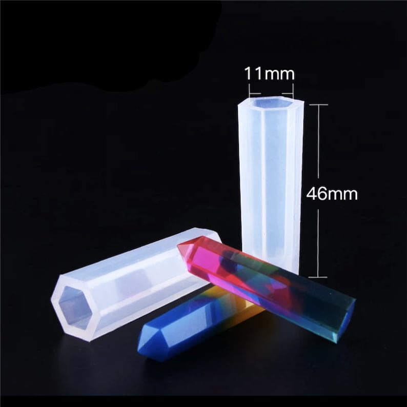 May include: A set of three clear silicone molds for making hexagonal crystal-shaped resin crafts. The molds are 46 mm long and 11 mm wide.