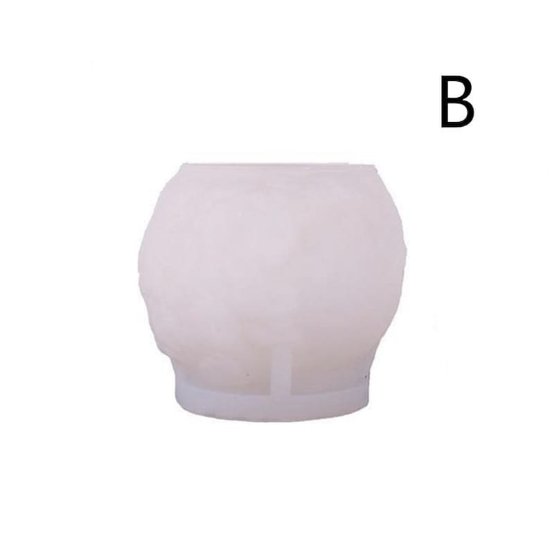 May include: A white, spherical mold with a textured surface. The mold has a flat base and a small support structure. The letter "B" is in the upper right corner.