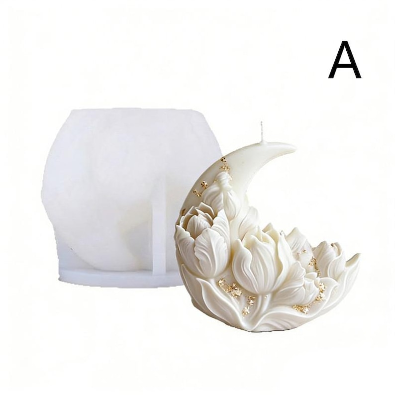 May include: A white, crescent-shaped candle with a floral design, featuring detailed tulip-like blossoms. The candle has gold flecks and a wick. A white, hexagonal mold is to the left of the candle. The letter "A" is in the upper right corner.