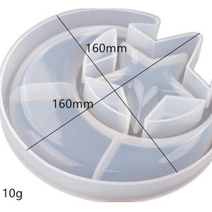 May include: A clear silicone mold shaped like a crescent moon with a star inside. The mold is 160mm in diameter and 12mm tall. The mold weighs 110g.