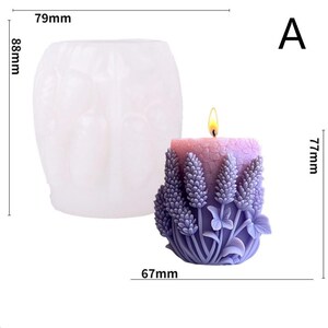 May include: A lavender-scented candle with a floral design, measuring approximately 3 inches in diameter and 3 inches tall, next to a clear silicone mold. The candle features a detailed relief of lavender sprigs and leaves. The candle is lit with a small flame.