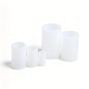Può includere: Un set di quattro stampi cilindrici in silicone bianco traslucido di varie altezze e diametri. Ogni stampo presenta un design liscio con apertura superiore e centro cavo, disposti in fila dal più piccolo al più grande su una base bianca.