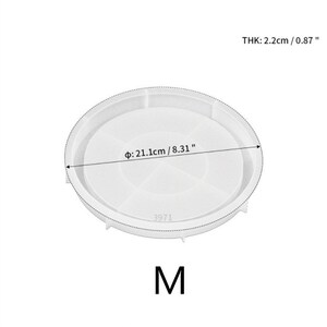 May include: White silicone mold for making resin crafts. The mold is round with a diameter of 8.31 inches and a thickness of 0.87 inches. The mold has a number "3971" printed on it and the letter "M" printed below it.