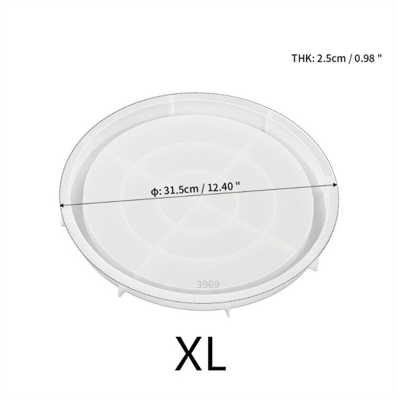 May include: White silicone cake pan with a diameter of 12.40 inches and a thickness of 0.98 inches. The pan has a smooth surface and a raised edge. The pan is labeled "XL" and "3969".