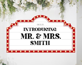 May include: A rectangular sign with a red border and small, round lights. The sign reads "INTRODUCING MR. & MRS. SMITH" in bold, black letters. The date "08.12.25" is above the text. The background is white with floral decorations.