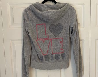 May include: Gray hooded sweatshirt with a pink and silver glitter "LOVE JUICY" design on the back.