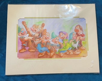 May include: A framed print featuring a watercolor illustration of the Seven Dwarfs playing musical instruments. The artwork depicts the characters in colorful outfits, with a light green and yellow border.