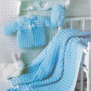 May include: A baby blue crocheted blanket, hat, jacket, and booties set. The set is made with a textured stitch and has white trim.