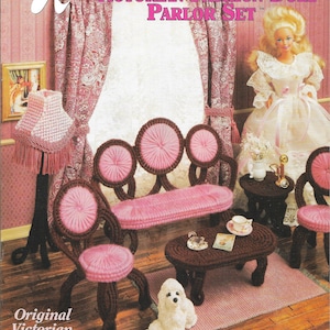 Könnte beinhalten: Ein Plastik-Canvas-Bastelmuster für ein viktorianisches Puppenstuben-Salon-Set. Das Set enthält ein Sofa, zwei Stühle, einen Couchtisch und einen kleinen Teppich. Das Muster ist von Annie's Attic und zeigt eine Puppe in einem weißen Kleid.