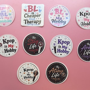 May include: A collection of ten circular and square vinyl stickers featuring various K-pop and BL themed designs with text including Kpop is My Hobby, BL is Cheaper than Therapy, The Stay Life Chose Me, The Army Life Chose Me, and The Atiny Life Chose Me.