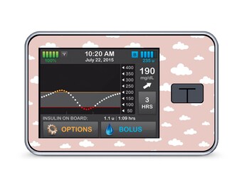 May include: A pink and white insulin pump with a cloud pattern. The screen displays a blood sugar reading of 190 mg/dL and a time of 10:20 AM on July 22, 2015. The screen also shows a graph of blood sugar levels over the past 3 hours.