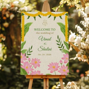May include: A welcome sign for a wedding with a floral design. The sign is on an easel and says "Welcome to the wedding of Vimal & Shalini 04.24.2026".