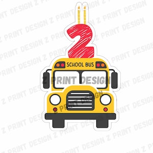 May include: A yellow school bus with a red number two on top. The number two has two candles on top of it. The bus has the words "School Bus" written on the front.