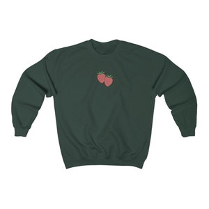 May include: A dark green sweatshirt with a small embroidered image of two red strawberries on the front.