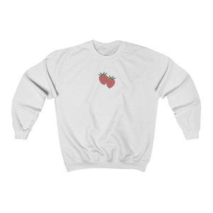 May include: White sweatshirt with a small embroidered image of two red strawberries on the front.