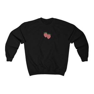 May include: Black sweatshirt with a small embroidered design of two red strawberries on the front.