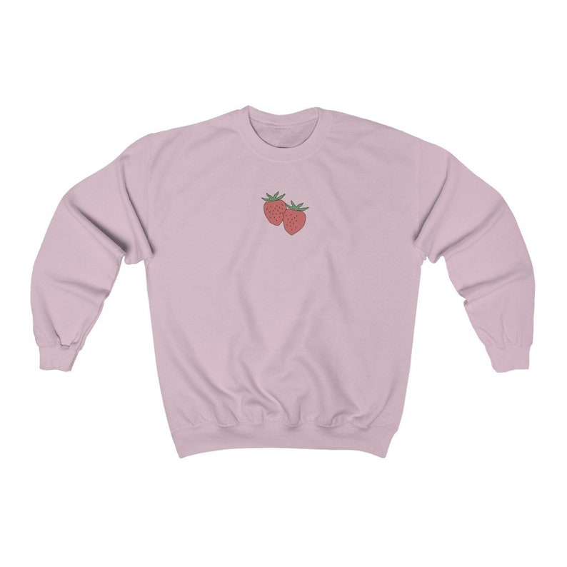 May include: A light pink sweatshirt with a simple embroidered design of two red strawberries.