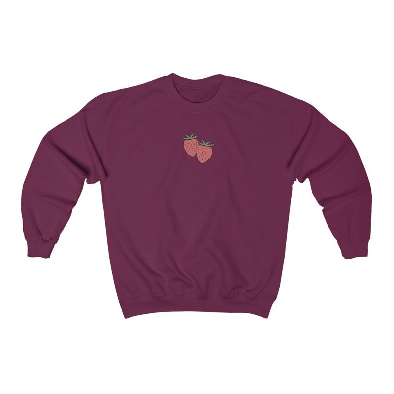 May include: A maroon sweatshirt with a small embroidered design of two red strawberries on the front.