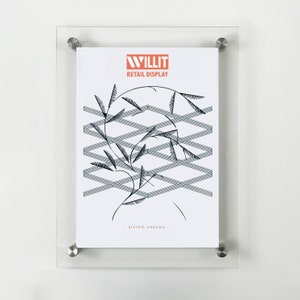 May include: A clear acrylic frame with a white poster inside. The poster features a black and white illustration of a plant with a geometric pattern behind it. The poster also includes the text "WILLIT RETAIL DISPLAY" and "BISTRO URBANO".