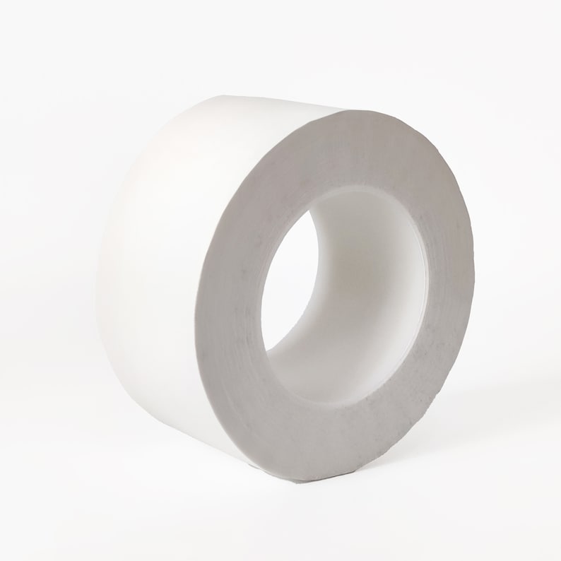 May include: A roll of white tape on a white background.