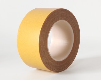 May include: A roll of double-sided adhesive tape with a yellow outer layer and a brown inner layer.