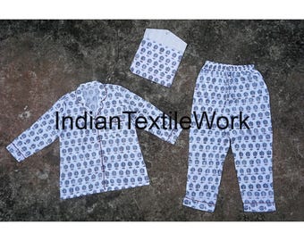 May include: A white pajama set with a blue and white floral print. The set includes a long-sleeved shirt with a button-up front and matching pants.