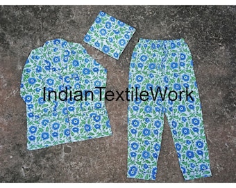 May include: A white pajama set with a blue floral print. The set includes a long-sleeved shirt with a collar and a pair of pants. "Indian Textile Work" is printed on the pants.
