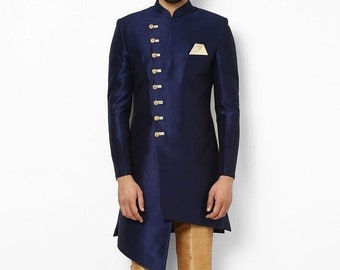 May include: A navy blue long-sleeved kurta with gold buttons and a diagonal hemline. The kurta is paired with gold pants and black shoes.