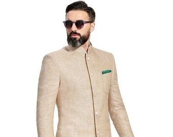 May include: A beige blazer with a mandarin collar and a single button closure. The blazer has a pocket on the left side and is worn with dark blue pants and brown leather shoes.