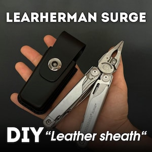 May include: A silver multi-tool with the text "LEATHERMAN SURGE" and a black leather sheath. The text "DIY "Leather sheath" is also visible. The multi-tool is open, displaying its pliers.