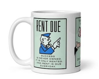 May include: White ceramic mug with a Monopoly-themed design. The mug features a green and white card with the text "Rent Due" and an illustration of the Monopoly game's landlord character. The text on the card reads "Success is never owned. It is only rented. And rent is due everyday."