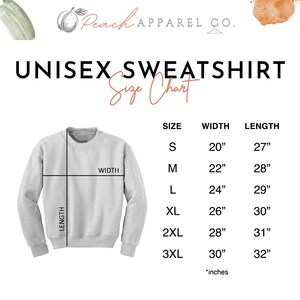 Op de afbeelding: Unisex sweatshirt maattabel met metingen in inches. De tabel toont de breedte en lengte van de sweatshirt in de maten S, M, L, XL, 2XL en 3XL.