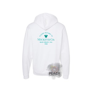 May include: White hooded sweatshirt with a teal blue Mickey Mouse logo and the text "Please return to Mickey & Co. Main Street, USA 1928" printed on the back.