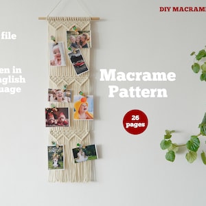 May include: A white macrame wall hanging with a diamond pattern. The hanging has a wooden dowel at the top and is decorated with photos held in place by clothespins. The text "Macrame Pattern" is written in white letters on a white wall. The text "26 pages" is written in white letters on a red circle.