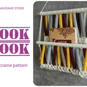 May include: DIY macrame book nook pattern. A macrame wall hanging with a book shelf, made with white, gray, yellow, and burgundy cord. The book nook is hanging on a gray wall.
