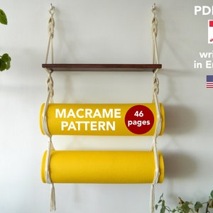 May include: A macrame shelf with two yellow cylindrical shelves. The shelf is made of white cord and has a wooden top shelf. The text "MACRAME PATTERN" and "46 pages" is written on the shelves. The text "PDF file" is written in the top right corner of the image. A PDF icon is next to the text. The text "written in English" is written below the PDF icon. An American flag is below the text.