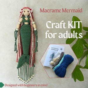 May include: A macrame mermaid craft kit for adults. The handmade mermaid has a green tail, a wooden head and arms, and long red and white hair. The kit includes instructions, wooden beads, and blue, gray, and teal colored yarn.