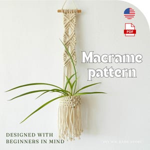 May include: A beige macrame plant hanger with a wooden dowel at the top, holding a green plant. The text "Macrame pattern" is displayed, along with "Designed with beginners in mind."