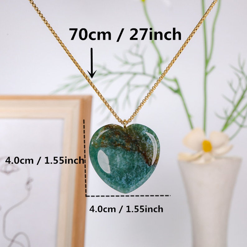 May include: A gold chain necklace with a green heart-shaped pendant. The pendant is 1.55 inches wide and 1.55 inches tall. The chain is 27 inches long.