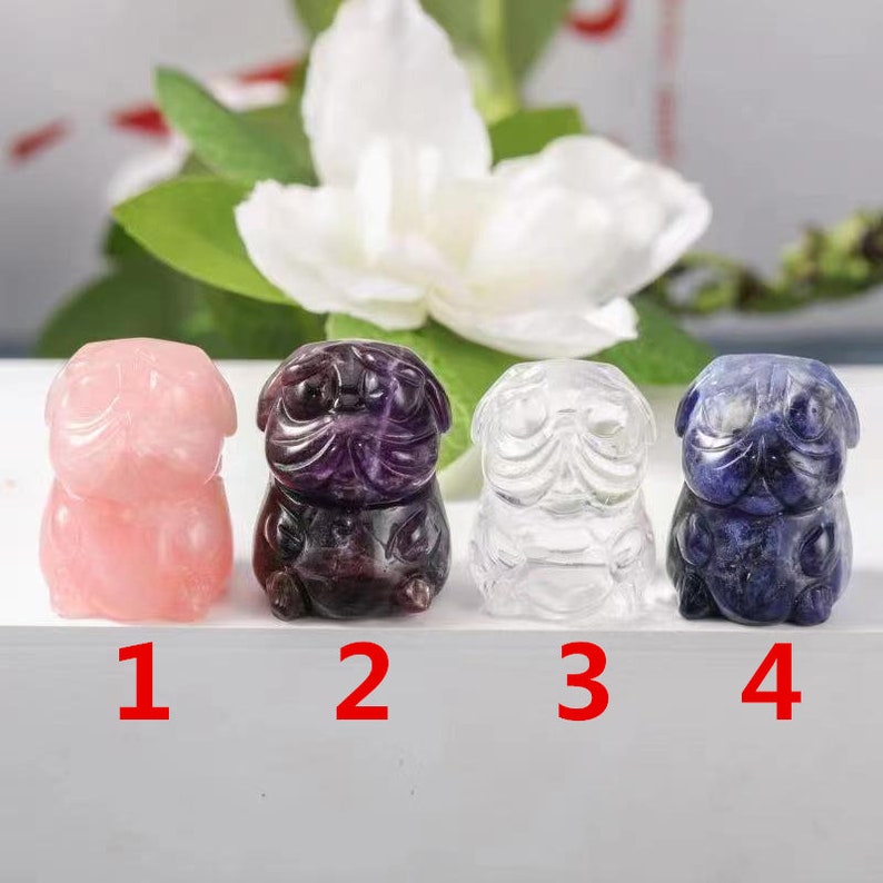 May include: Four small carved pug figurines made of different types of stone. The pugs are numbered 1 through 4. Pug 1 is pink, pug 2 is purple, pug 3 is clear, and pug 4 is blue.