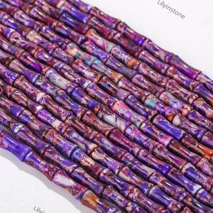 May include: Purple and white patterned cylindrical beads, resembling bamboo, for jewellery making.