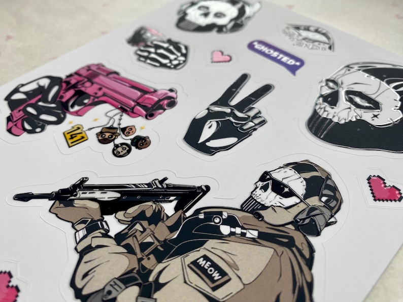 Puede incluir: Una hoja de pegatinas con varias ilustraciones, incluyendo una pistola rosa con una etiqueta 141, una mano esquel&eacute;tica haciendo el signo de la paz, una m&aacute;scara de calavera, un globo de texto morado con el texto GHOSTED y un soldado enmascarado.