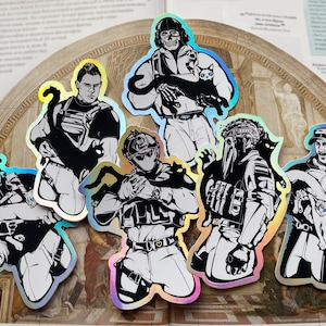 May include: A collection of holographic stickers featuring stylized illustrations of figures in tactical gear, each holding a black cat. The stickers have a black and white color scheme with iridescent edges, creating a striking visual effect.